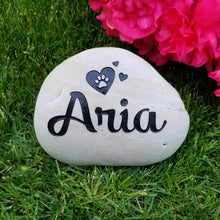 Load image into Gallery viewer, pet memorial stone.  Personalized with a name, paw print and hearts.  Natural river rock garden memorial or pet gravestone